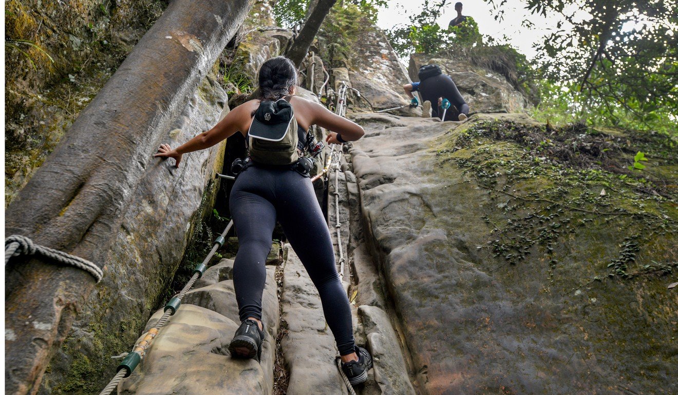 Hikers use ropes to descend one section of the Wuliaojian hiking trail. Photo: Chris Stowers/PANOS