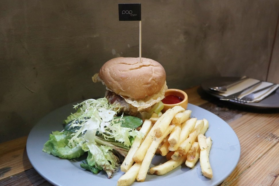 POP Vegan’s Barbecue Vegan Chicken Burger, which features hedgehog mushrooms, avocado, tomato and a layer of pineapple and comes with fries and salad.