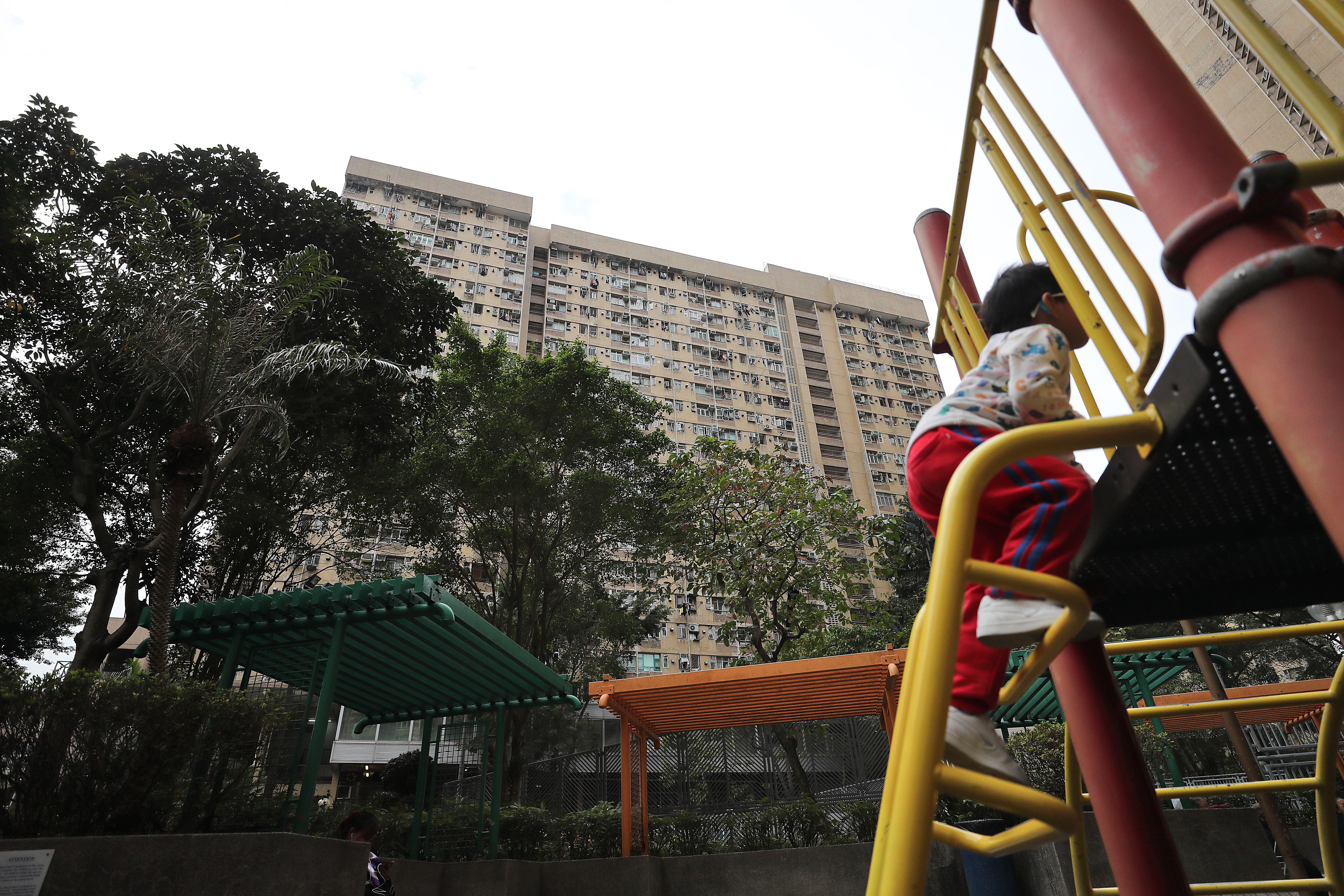 A child plays in front of Oi Wo House in an estate under the Tenants Purchase Scheme in Tai Wo on January 4. By promoting home ownership, the scheme has also facilitated family stability. Photo: Winson Wong