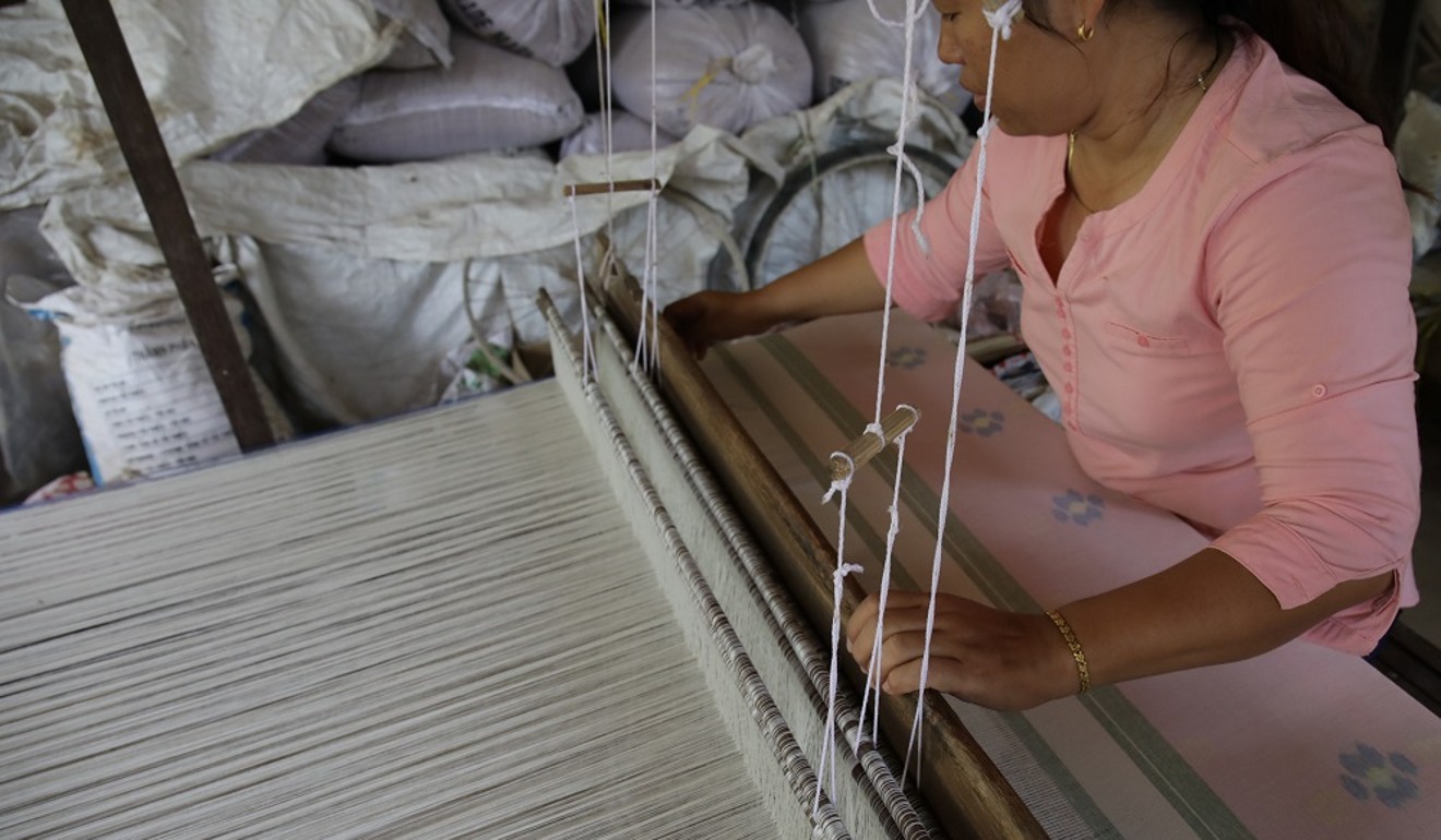 An artisan in Cambodia weaves a pastel pattern for the KBEN & HOL, Lane Crawford 2018 collection.