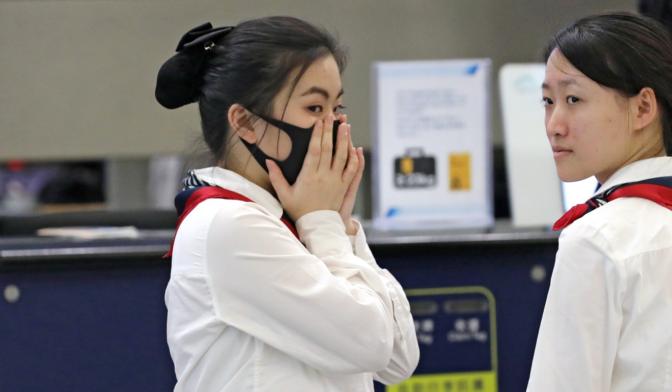 Staff at Hong Kong International Airport in Chek Lap Kok wearing surgical face masks during the outbreak of measles. Photo: SCMP Pictures
