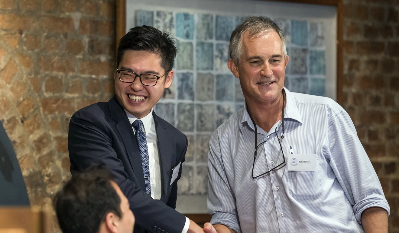 In this August 14, 2018 photo, Financial Times Asia news editor Victor Mallet (right) shakes hands with Andy Chan Ho-tin, founder of the Hong Kong National Party, during a luncheon at the Foreign Correspondents Club in Hong Kong. Photo: AP