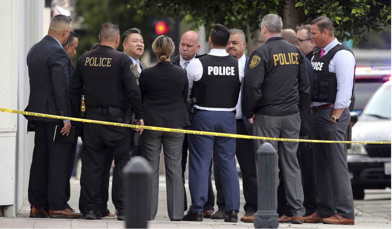 Investigators confer near the Scientology building in Inglewood, California. Photo: AP