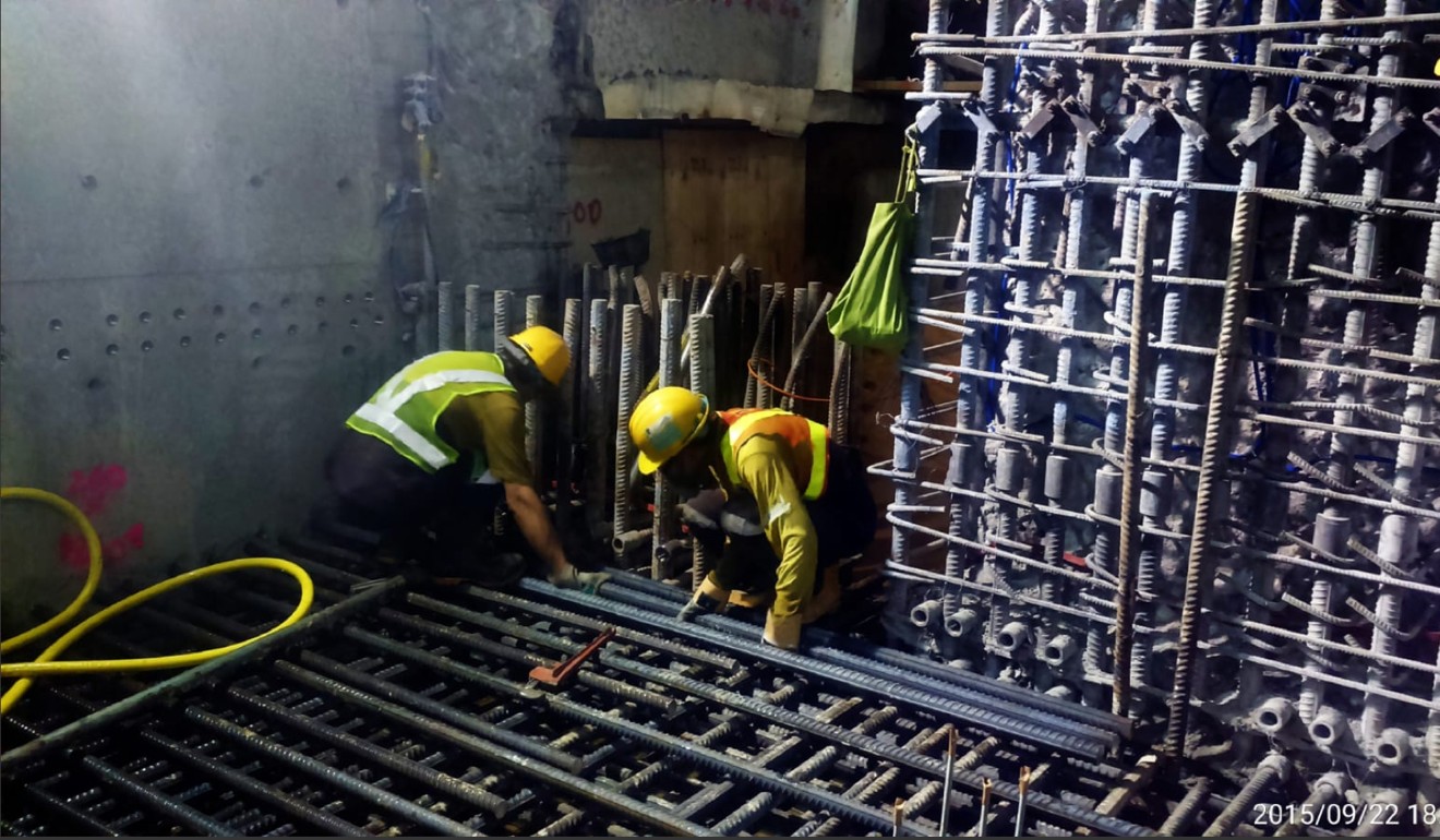 This photos, taken on 22 September 2015, showed two workers in Leighton uniforms and helmets cutting steel bars that formed the platform framework of the Hung Hom station for Hong Kong’s most expensive rail project. Photo: SCMP