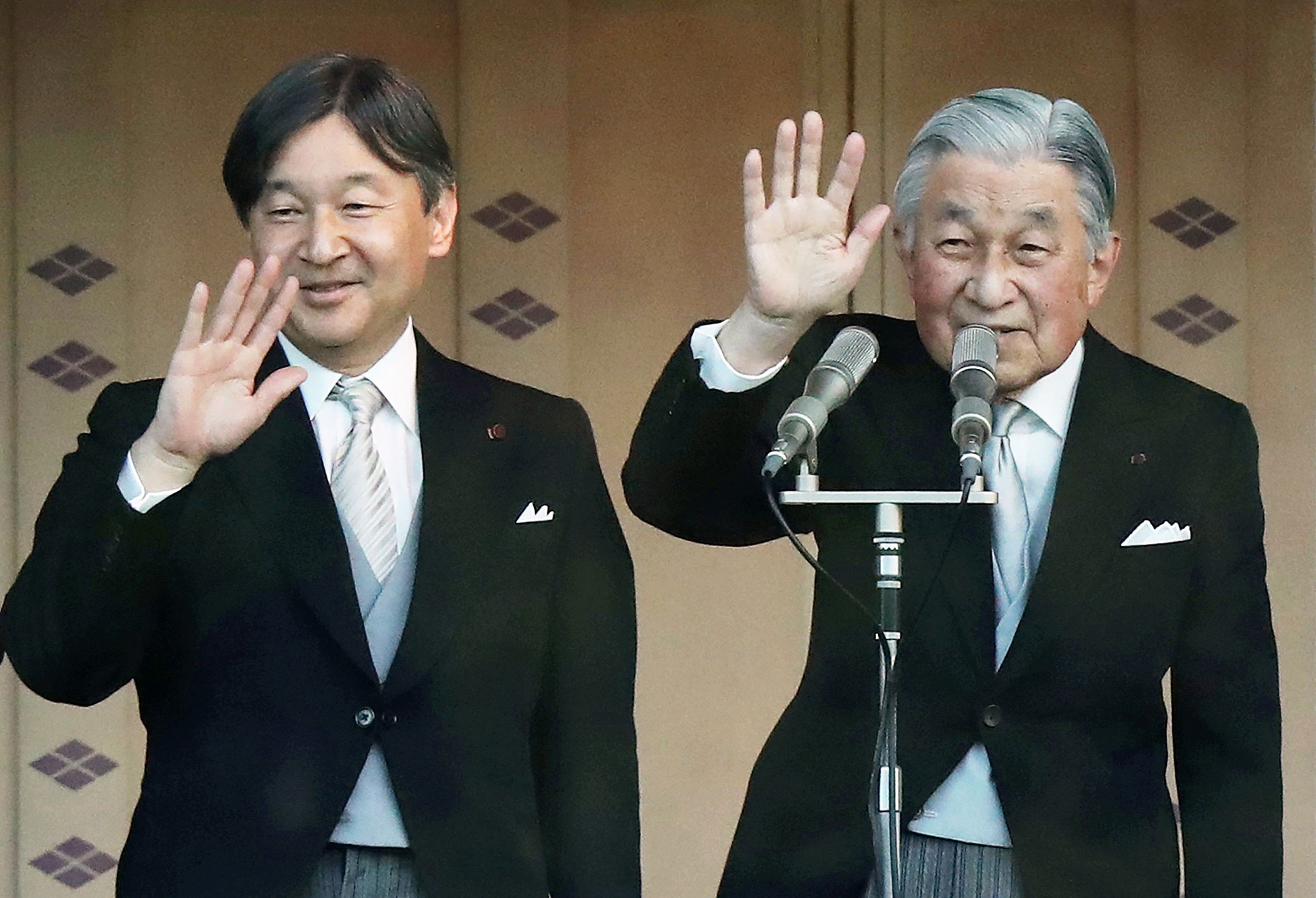 Japan’s Emperor Akihito (right) and Crown Prince Naruhito wave to the crowd at the Imperial Palace in Tokyo on January 2, after the emperor delivered his final New Year’s address. Photo: AFP