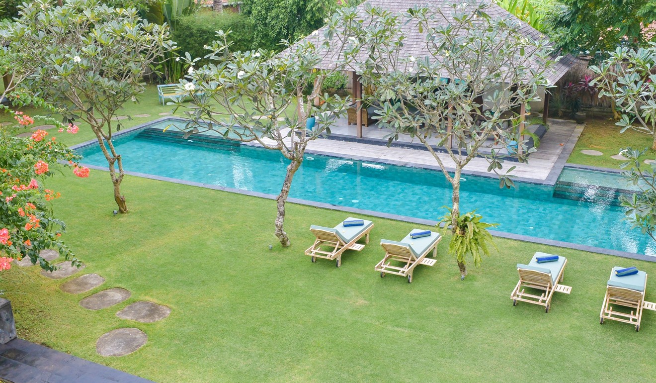 Umah Tenang villa, which features a 20-metre-long swimming pool, is located in the quiet Bali village of Seseh.