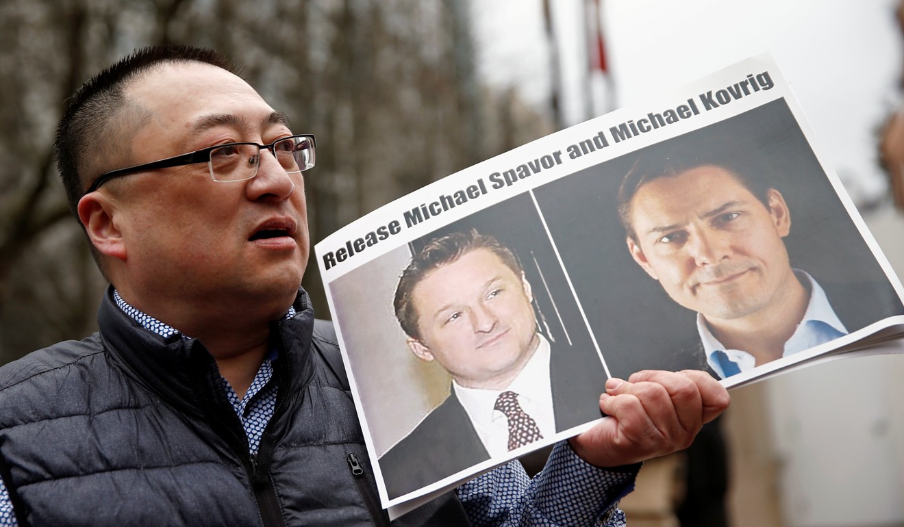 Louis Huang holds a placard calling for China to release Canadian detainees Michael Spavor and Michael Kovrig outside Meng Wanzhou’s hearing at the British Columbia Supreme Court in Vancouver, Canada, on March 6. Photo: Reuters