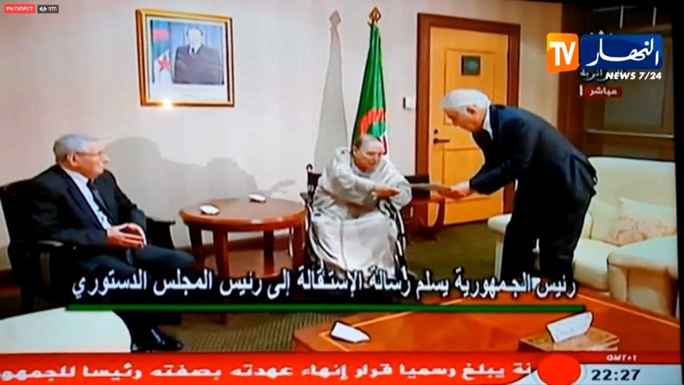 This scene from Ennahar TV on Wednesday shows Algeria’s ailing President Abdelazziz Bouteflika (centre) handing his resignation letter to the Constitutional Council's president Tayeb Belaiz in front of the President of the Algerian Senate Abdelkader Bensalah (left) in Algiers. Photo: AFP