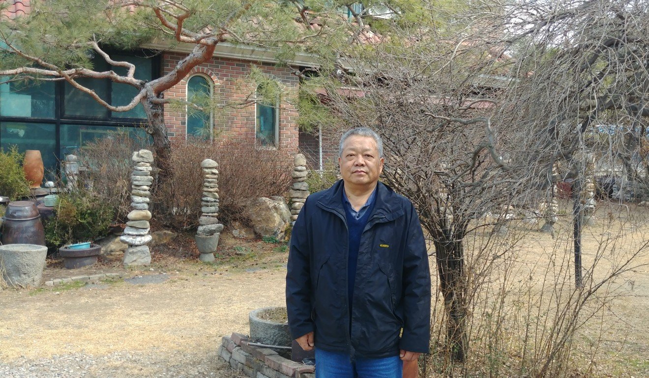 Ma Jian-xian outside his home, one of various properties he and his wife now own. Photo: Park Chan-kyong