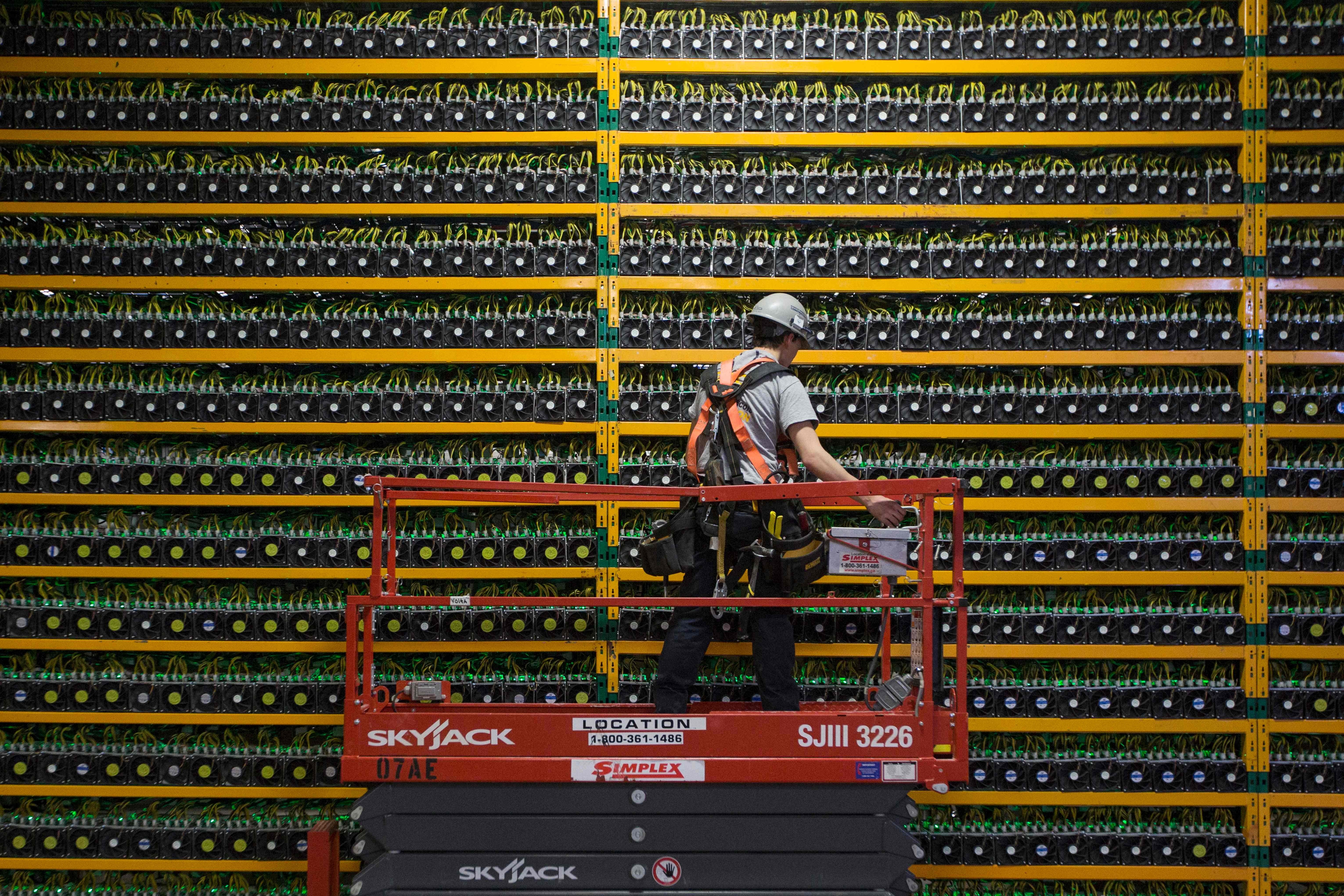 A technician inspects bitcoin mining machines at a cryptocurrency farming operation, Bitfarms, in Quebec. Blockchain is the decentralised database technology that underpins bitcoin and other digital currencies. Photo: AFP