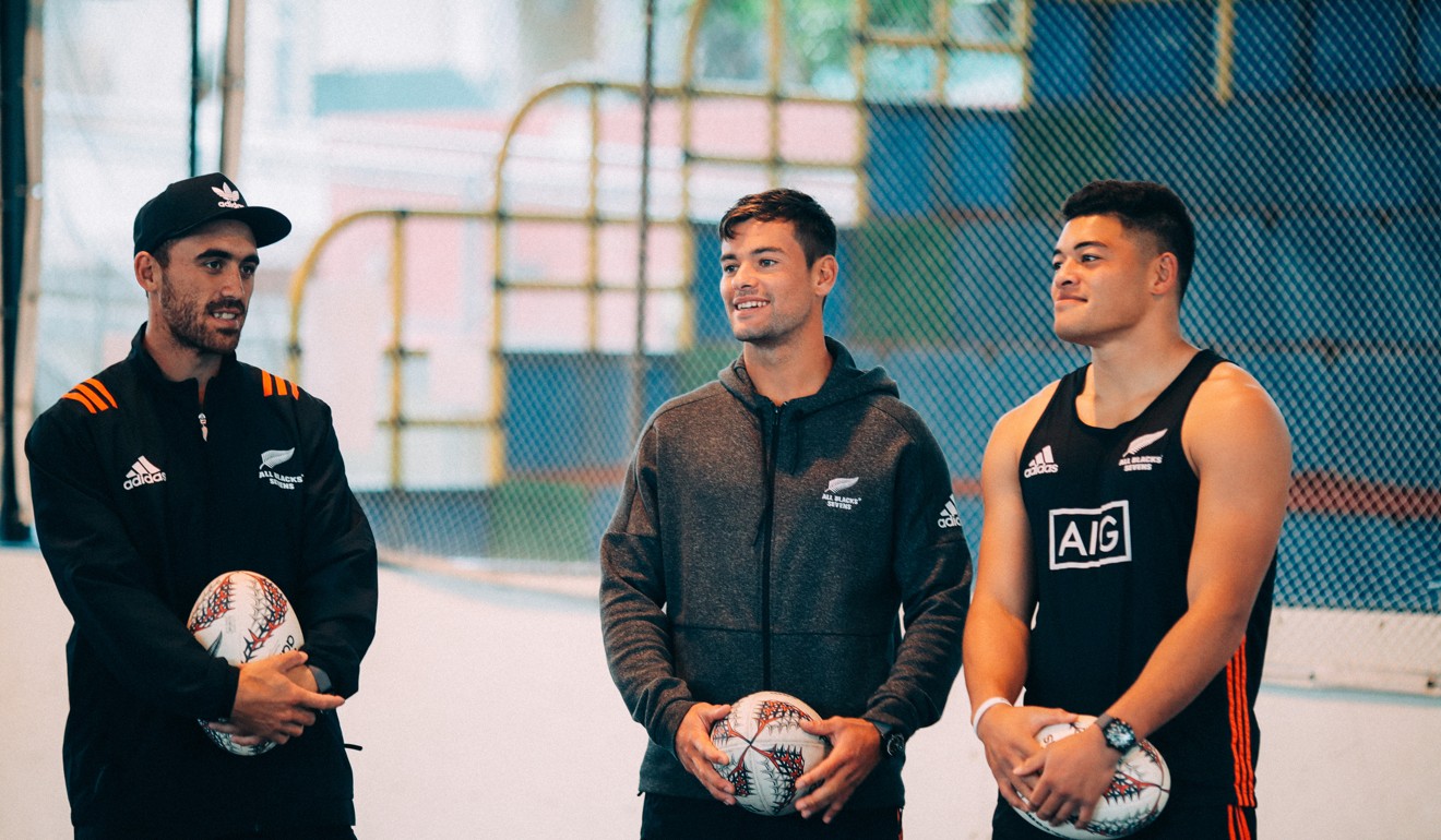 (From left) Joe Wedder, Andrew Knewstudd and Tone Ng Shiu from the New Zealand sevens team teach skills to journalists. Photo: Tudor