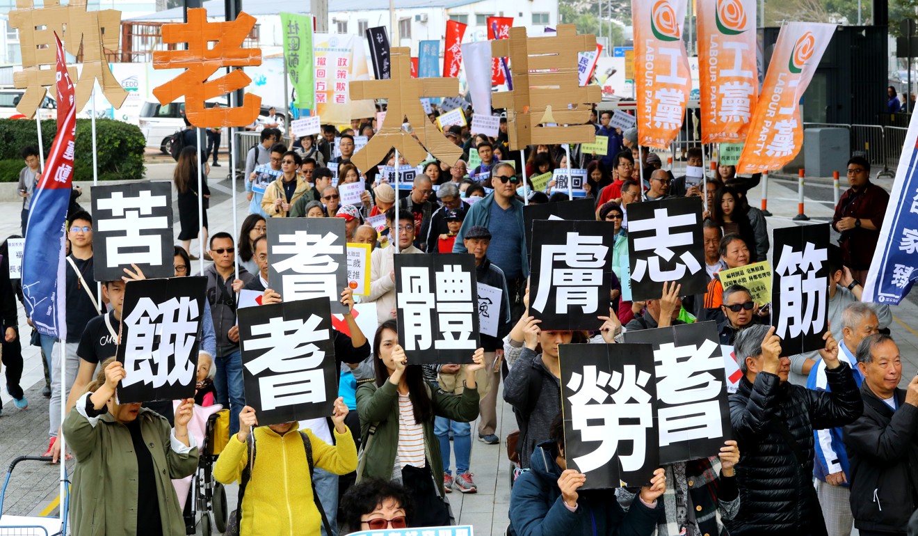 People march to the Hong Kong government’s headquarters in Tamar, Admiralty, on January 27 to protest against the changes to the age cut-off for elderly welfare payments. Photo: Edmond So