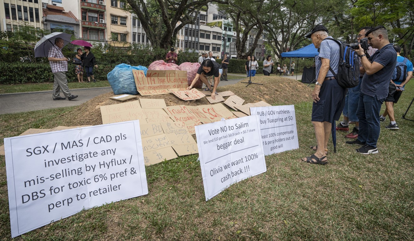 Signs displayed at a protest in Singapore on Hyflux’s debt restructuring plan. Photo: Bloomberg