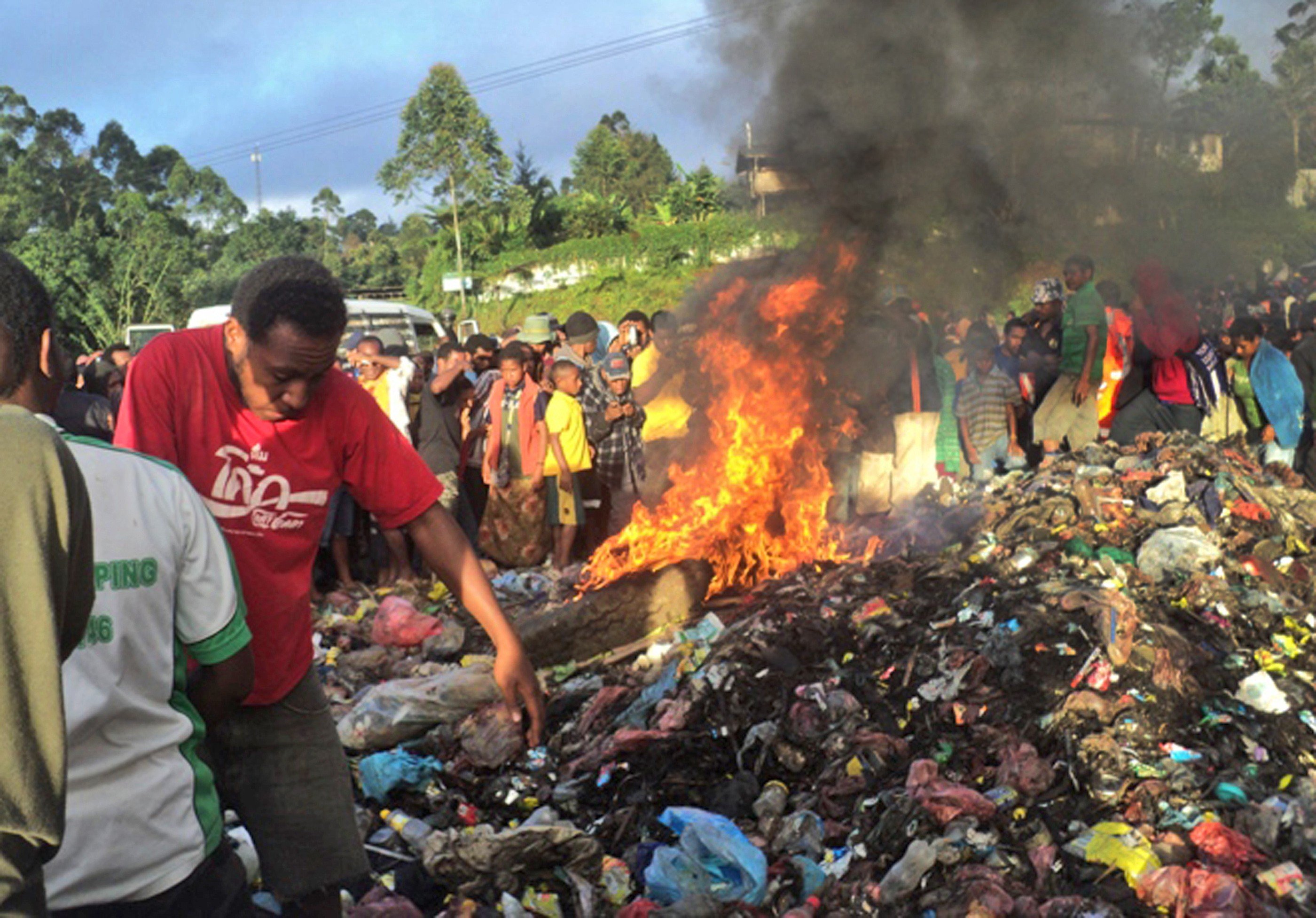 Purported to be the burning rubbish pile on Warakum Junction Road, in Mount Hagen, Papua New Guinea, on to which 20-year-old Kepari Leniata was thrown in 2013. Photo: AFP