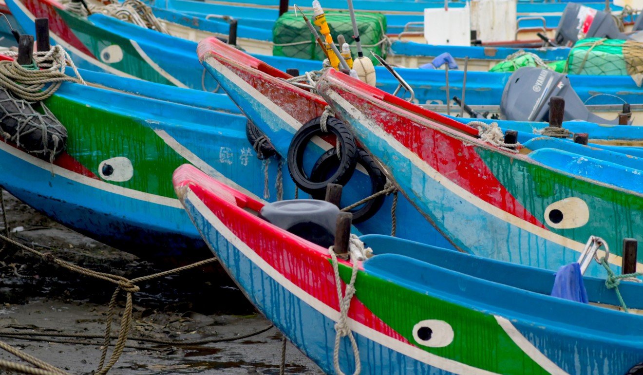 Traditional Taiwanese fishing boats are seen at low tide in Bali district, New Taipei City, on March 3, 2019. (Photo by Sam Yeh / AFP)