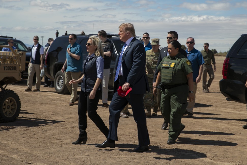 US President Donald Trump walks with Homeland Security Secretary Kirstjen Nielsen as they visit a newly refurbished part of a border wall with Mexico in Calexico, California, on Friday. Photo: AP