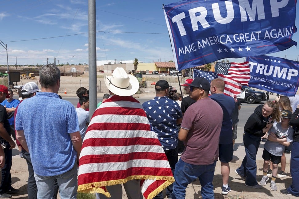 Supporters of US President Donald Trump stand near the US-Mexico border during a rally as Trump visits Calexico on Friday. Photo: Reuters