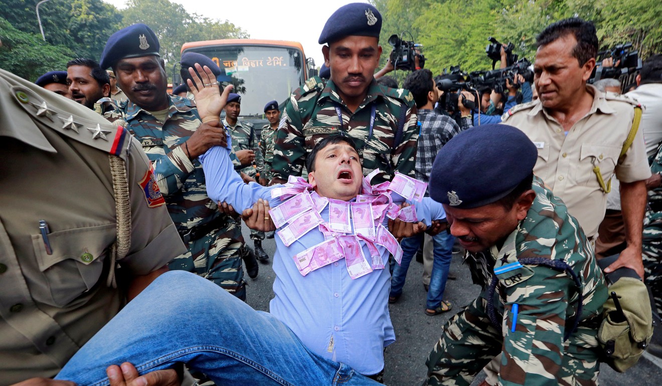 Police detain a man protesting against Narendra Modi’s unpopular demonetisation drive. Photo: Reuters