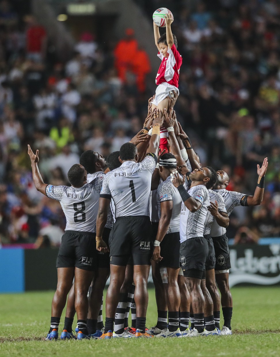 The Fijians provide a moment to remember for a young ballboy. Photo: Sam Tsang