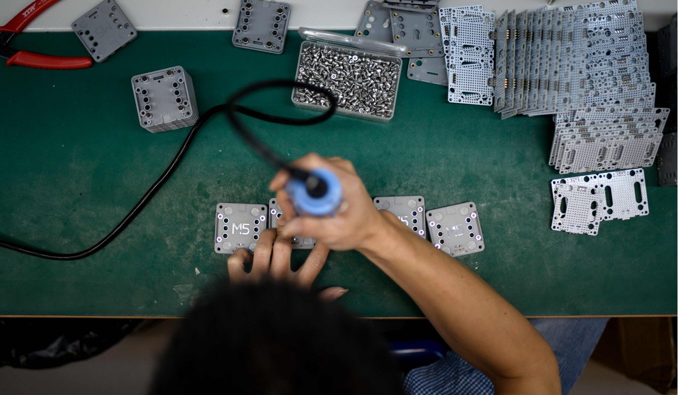 A worker at a factory producing robots in Shenzhen, China. Photo: AFP
