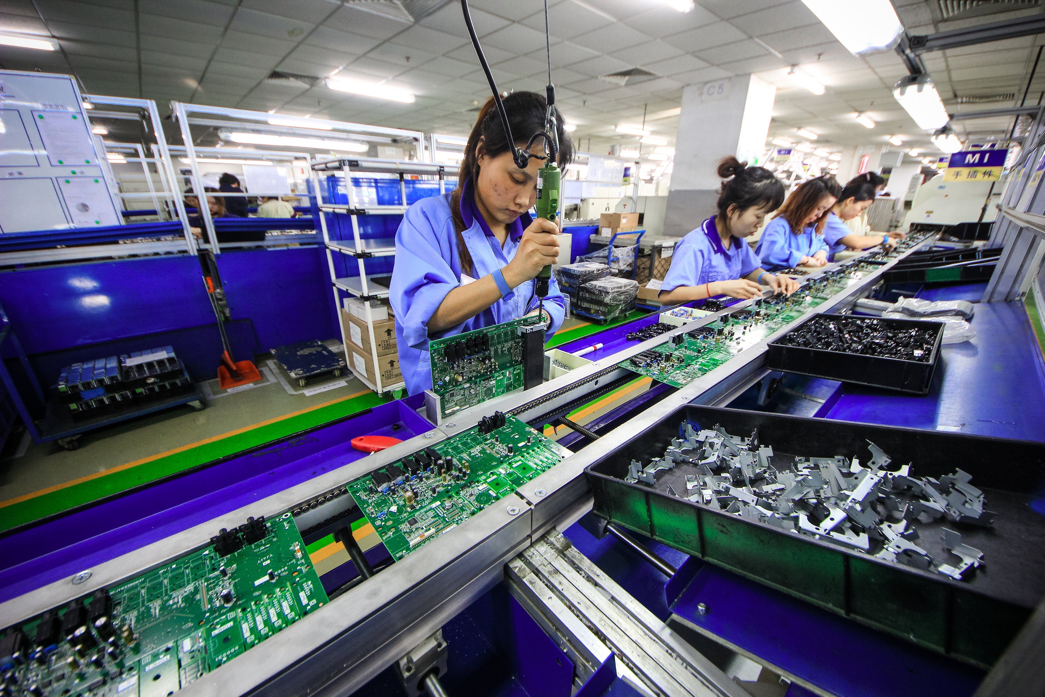 Workers at a production line manufacturing electronic keyboards in Tianjin, China. Photo: Reuters