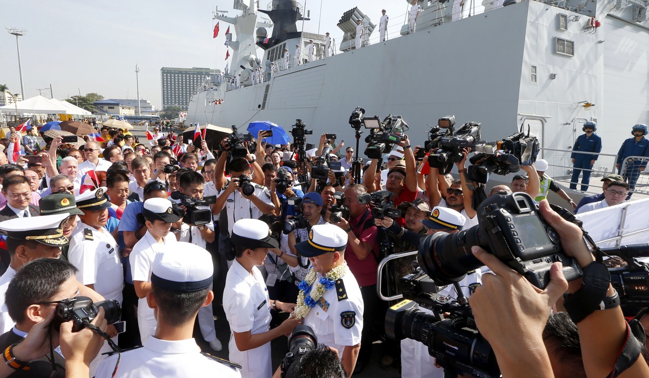Chinese Navy Rear Admiral Xu Haihua (centre) receives a lei from a Philippine navy officer after a Chinese guided-missile frigate docked at Manila’s South Harbor for a four-day port call on January 17, 2019. Photo: AP