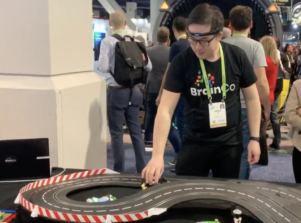 A BrainCo employee adjusts toy cars on a miniature track at the company’s booth in the CES trade show in Las Vegas in January this year. Photo: YouTube
