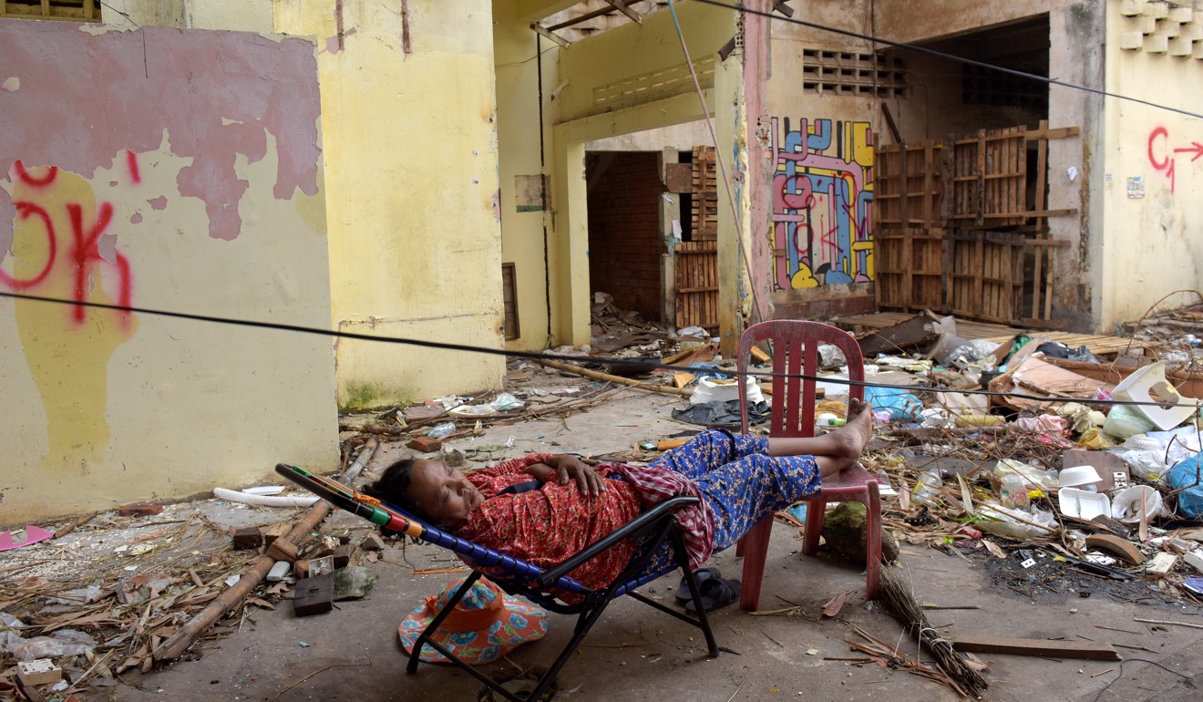 A Cambodian woman sleeps at the residential complex known as the White Building in Phnom Penh before its demolition. Photo: AFP
