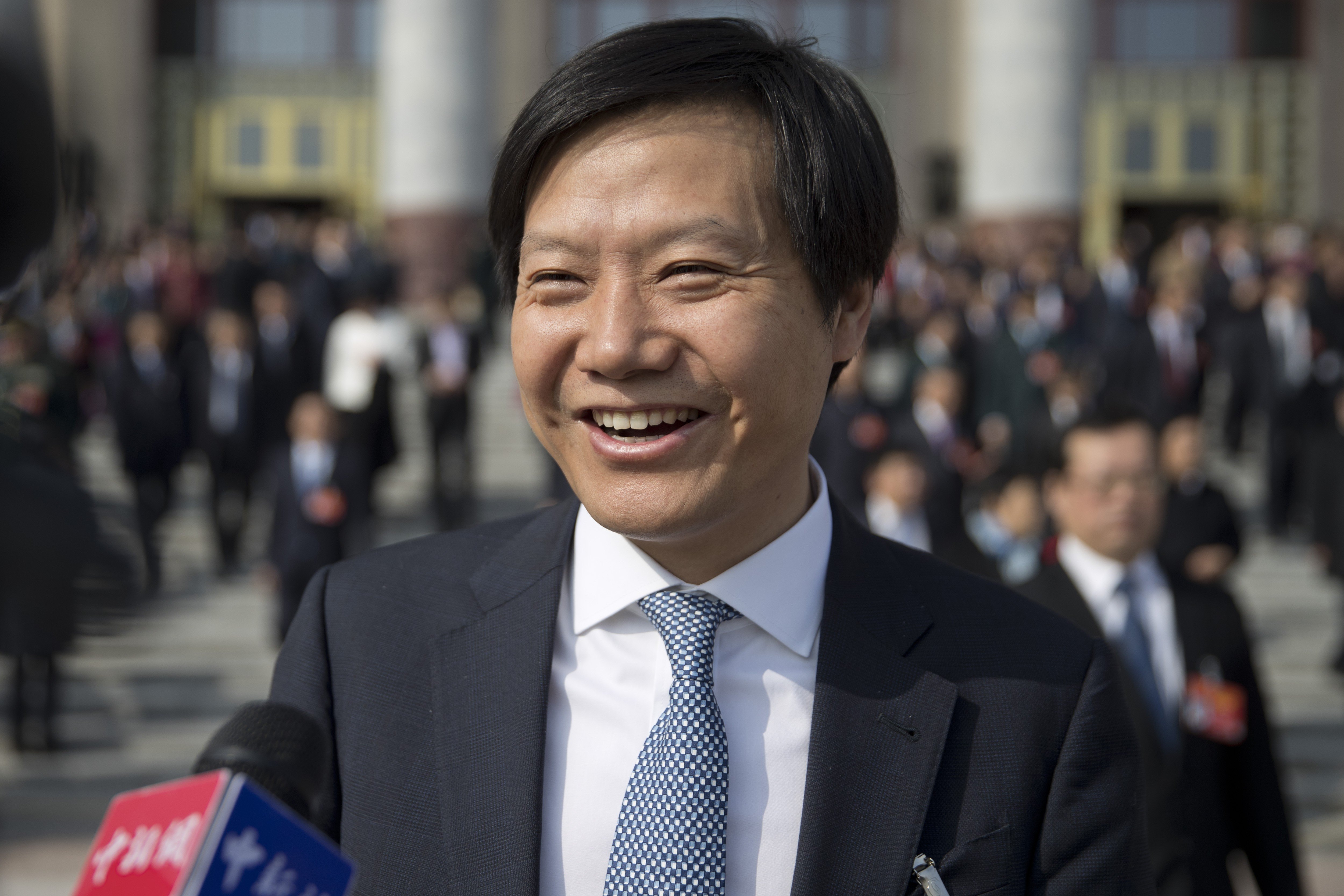 Xiaomi founder, chairman and chief executive Lei Jun speaks with journalists as he leaves a meeting one day ahead of the opening session of China's National People's Congress in Beijing on March 4, 2019. Photo: AP