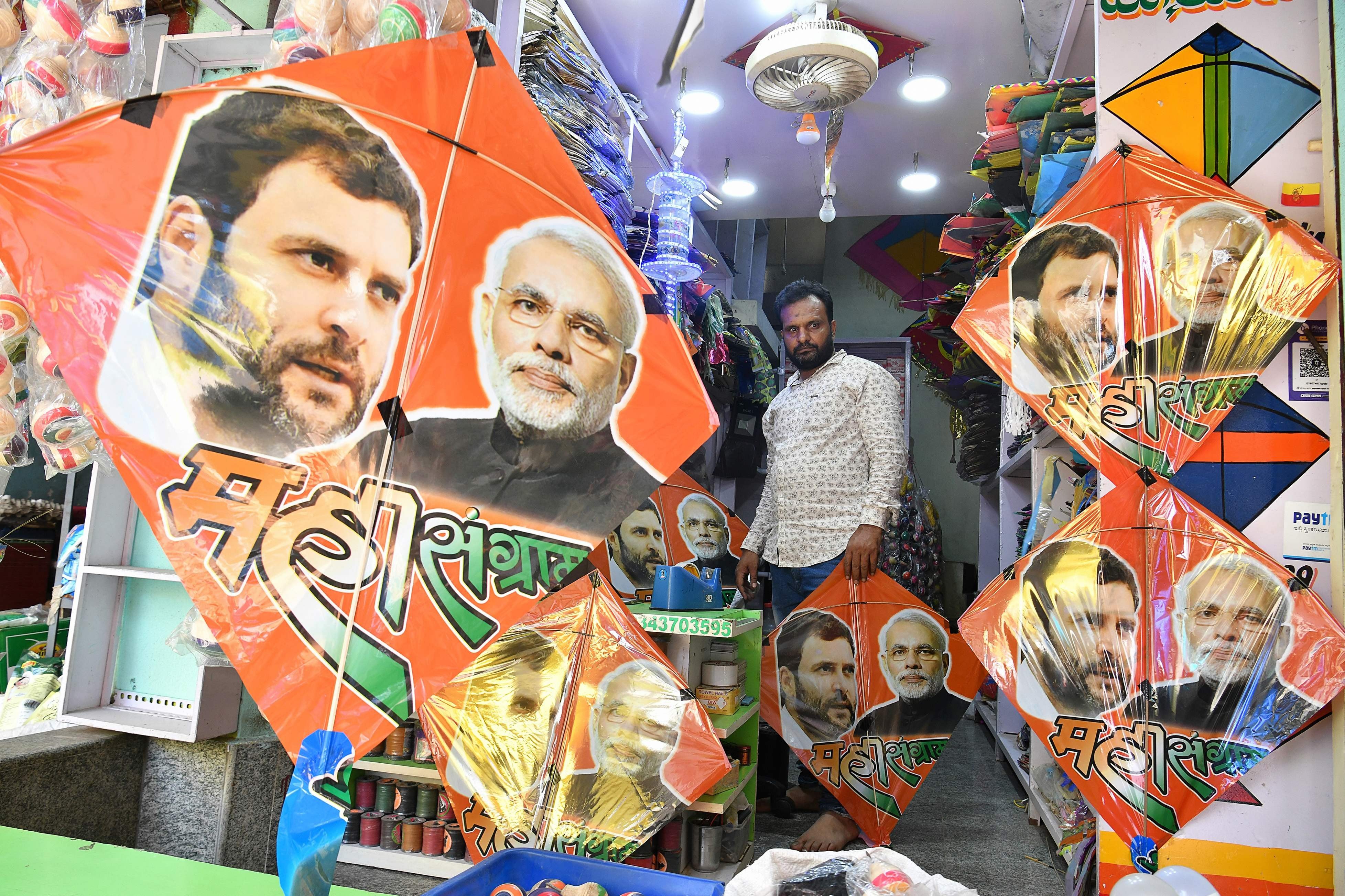 A shop assistant sells kites bearing images of the Indian political rivals, Prime Minister Narendra Modi and Congress President Rahul Gandhi in Bangalore. Photo: AFP