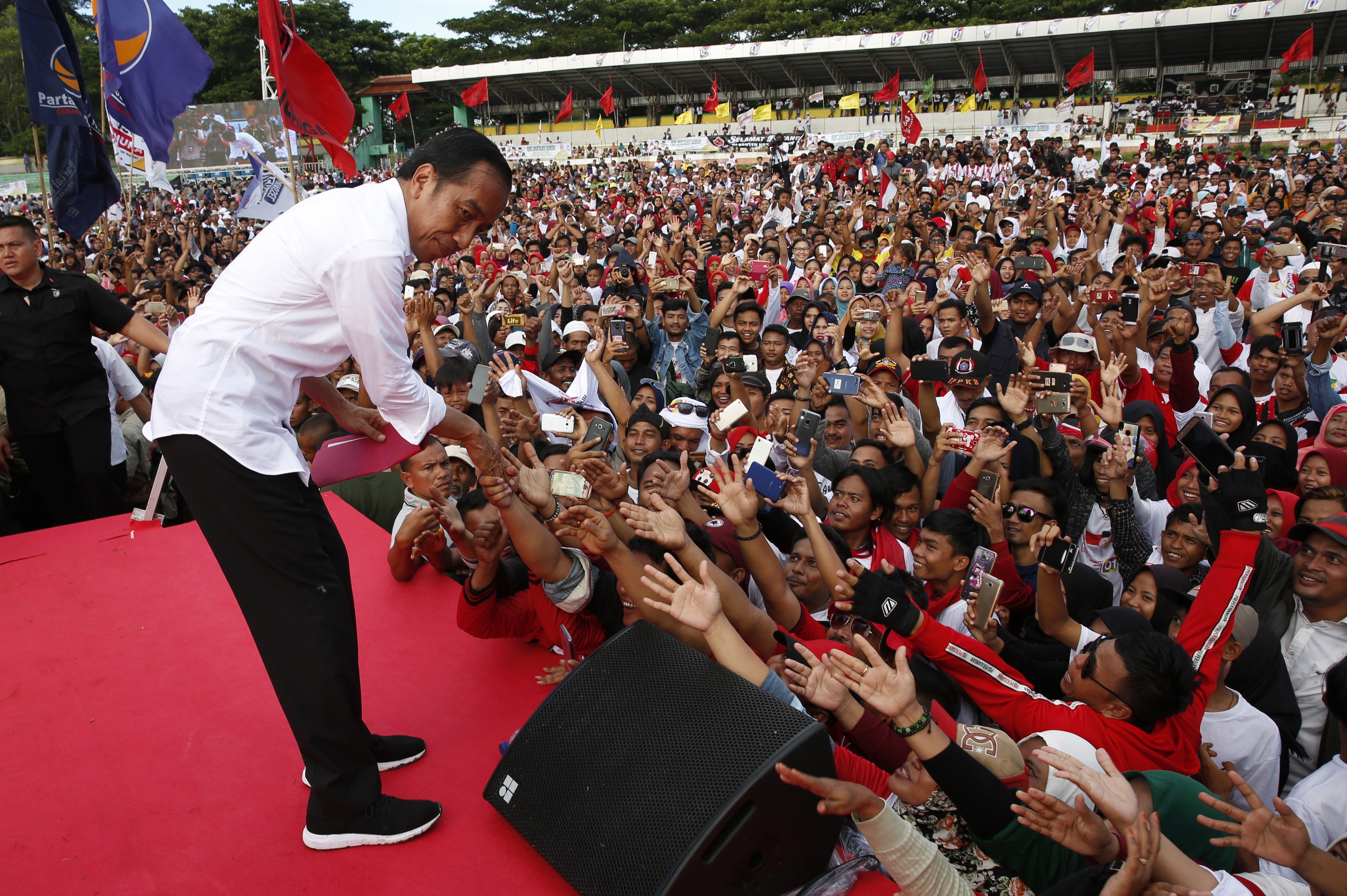 President Joko Widodo meeting supporters at a campaign rally. Photo: EPA-EFE