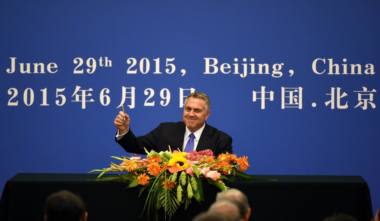 Joe Hockey, then Australia’s treasurer, holds up his pen as he becomes the first to sign articles of association to help set up the Asian Infrastructure Investment Bank during a ceremony at the Great Hall of the People in Beijing in 2015. Recently, Hockey was quoted encouraging the US to go all out in its trade war with China. Photo: AFP