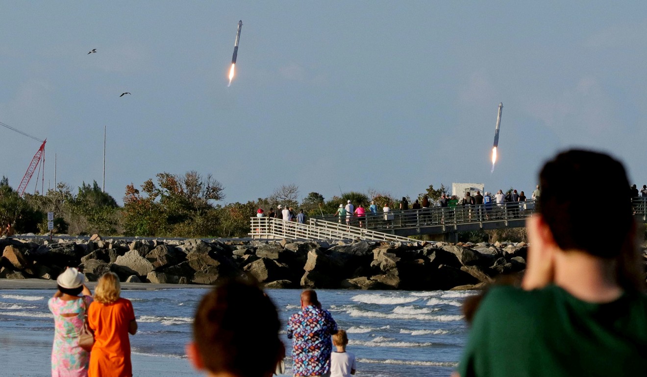 Spectators watch from Jetty Park as the booster rocket engines approach their landing pads. Photo: Reuters
