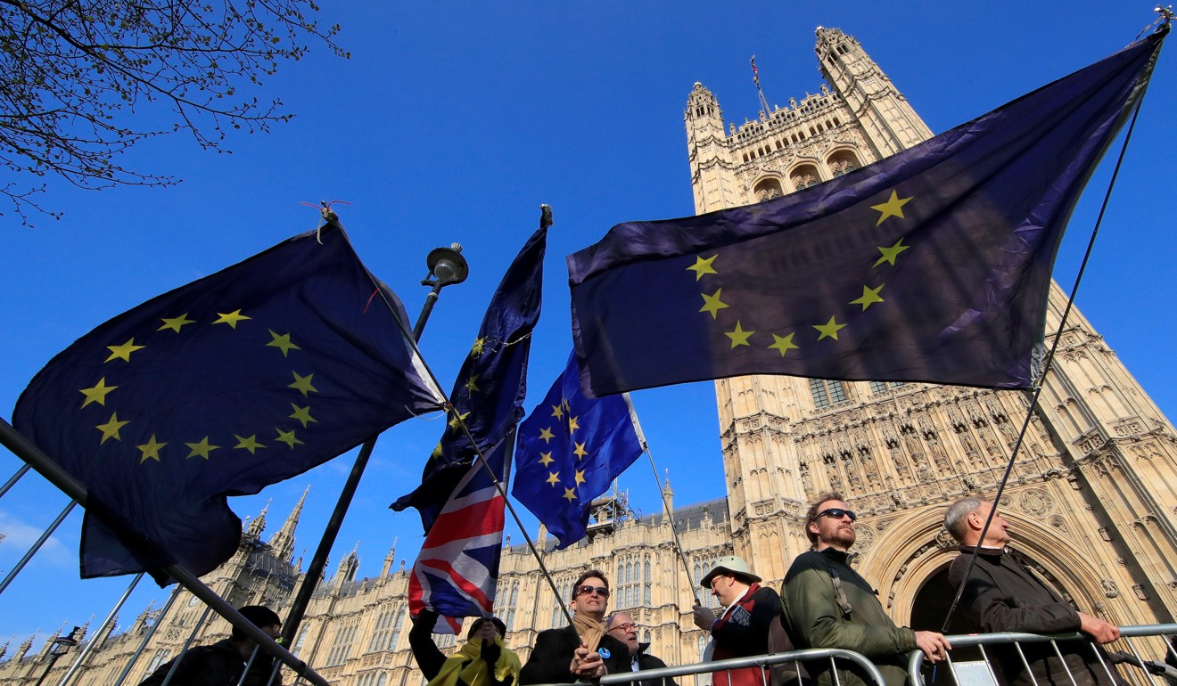 Anti-Brexit protesters hold EU flags as they demonstrate outside the Houses of Parliament on Thursday, April 11, 2019. Photo: Reuters