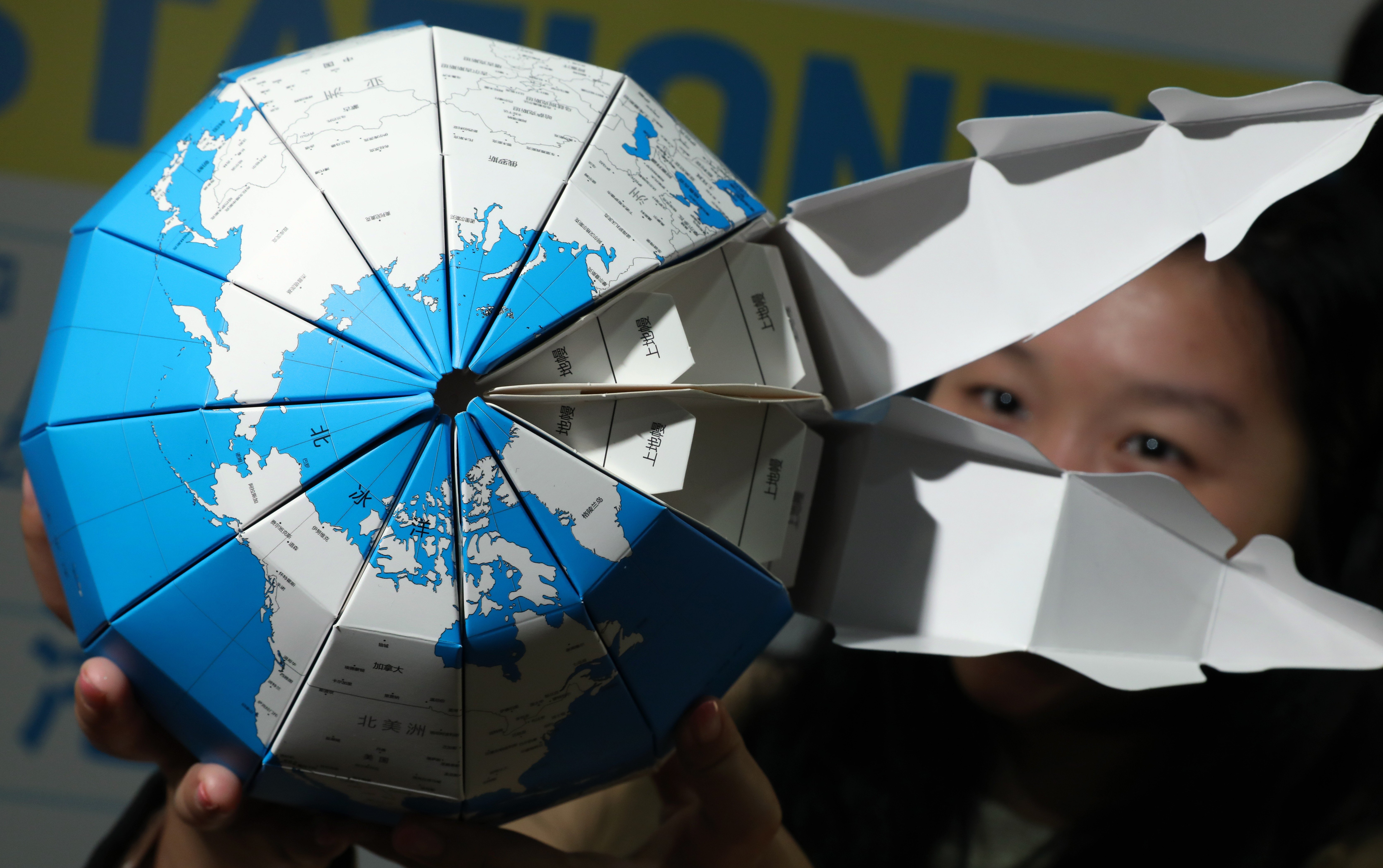 A representative of Shangdong Orange Paper Import and Export Company introduces its paper globe at a trade fair in Hong Kong in January. The “China model” of development has come under attack recently for being insufficiently open to foreign companies. Photo: Nora Tam