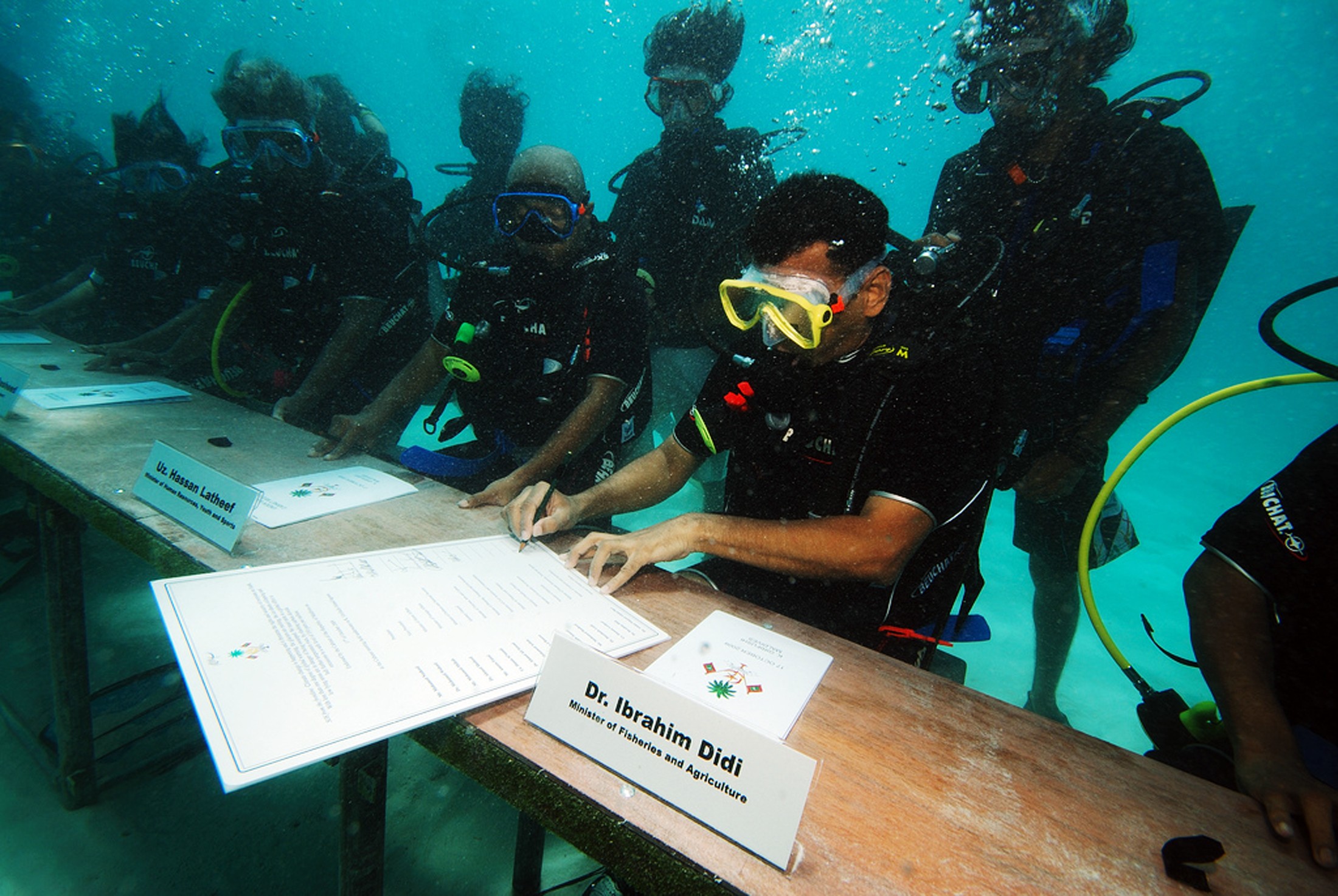 Ibrahim Didi, Minister of Fisheries and Agriculture of the Maldives signed the decree of the underwater cabinet meeting off Girifushi Island on October 17, 2009. Ministers in full scuba gear met on the seabed to draw attention to the dangers of global warming for the island nation, a tourist paradise featuring coral reefs and white sand beaches with most parts lying less than one metre (3.3 feet) above sea level. Scientists have warned it could be uninhabitable in less than 100 years. Photo: Agence France-Presse