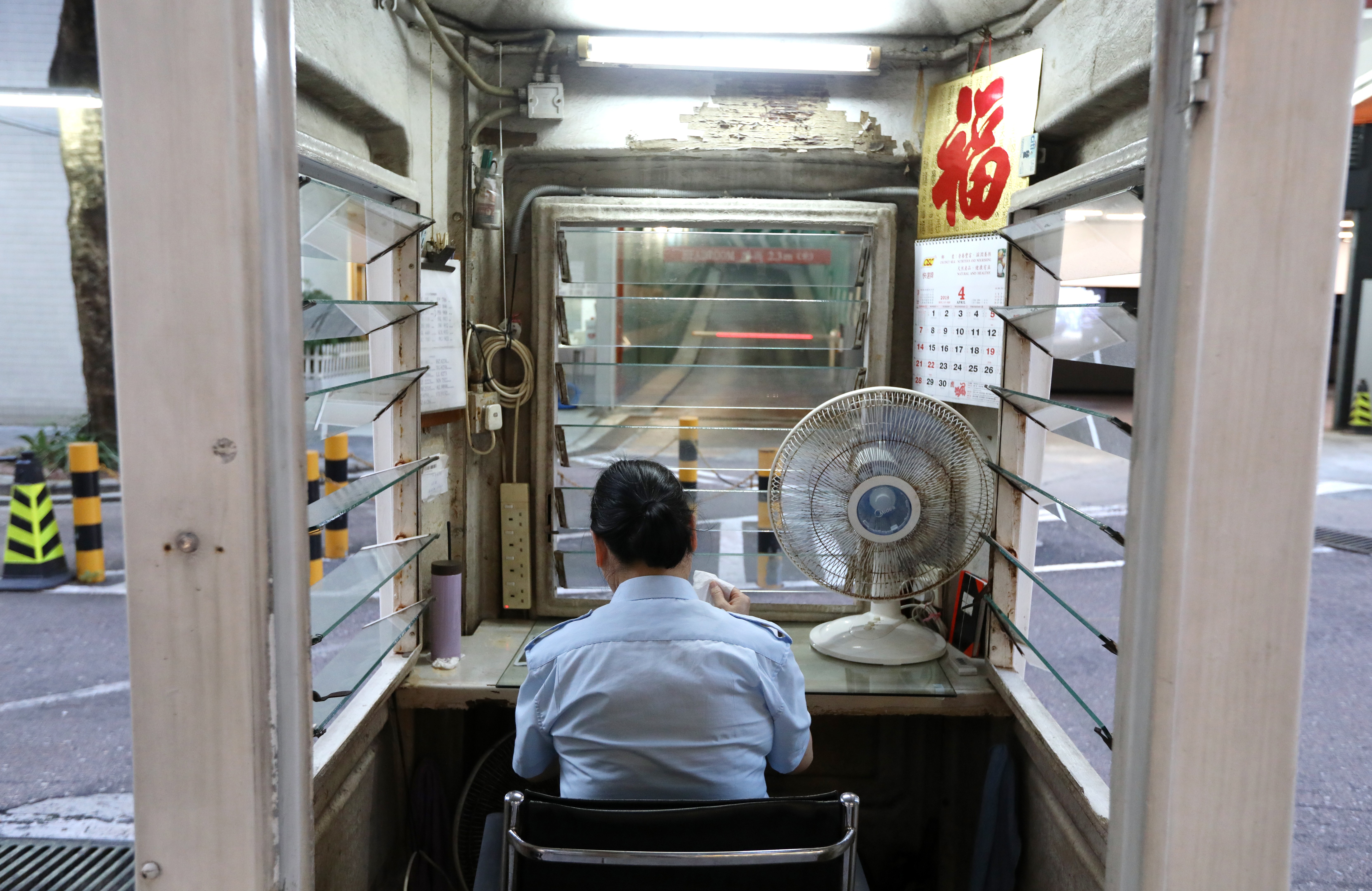 A security guard on duty at the Whampoa Estate in Hung Hom. Photo: Roy Issa