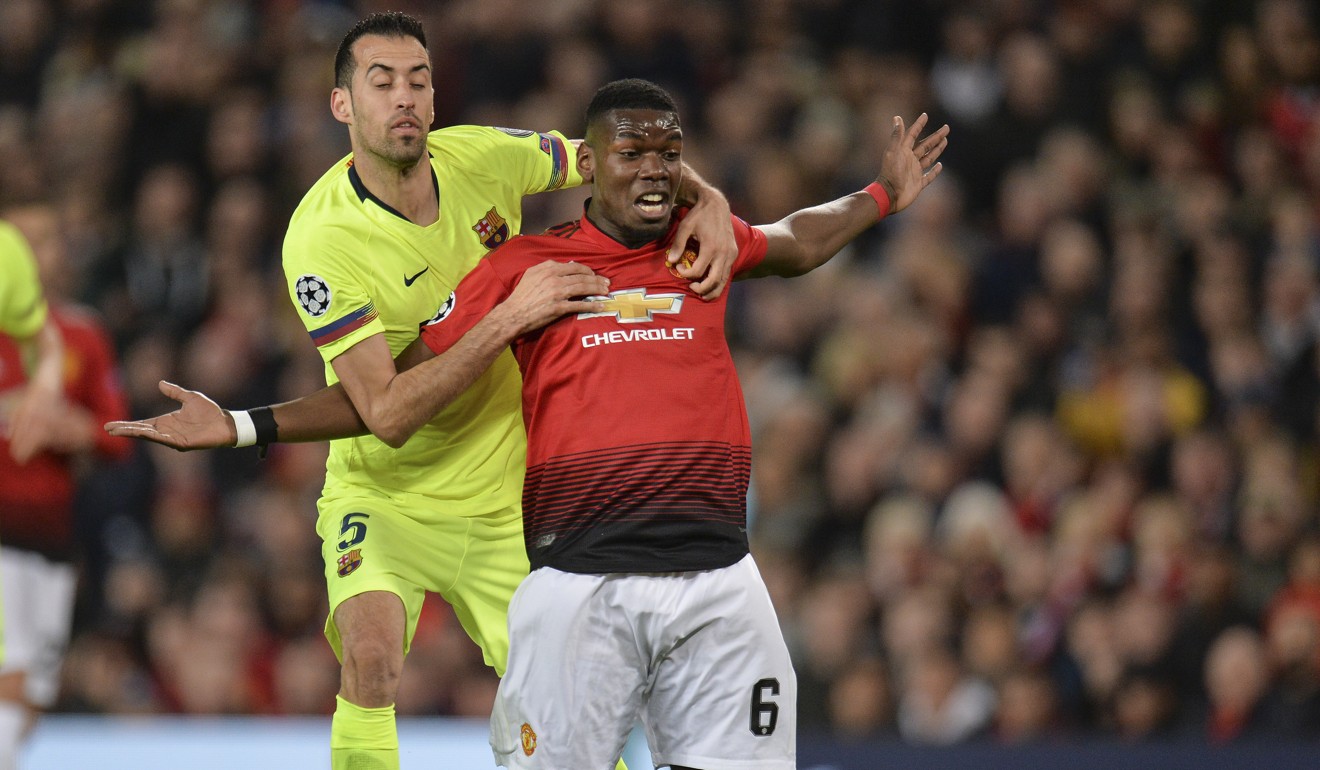 Sergio Busquets of FC Barcelona (left) and Paul Pogba of Manchester United (right) in action during the UEFA Champions League quarter final. Photo: EPA