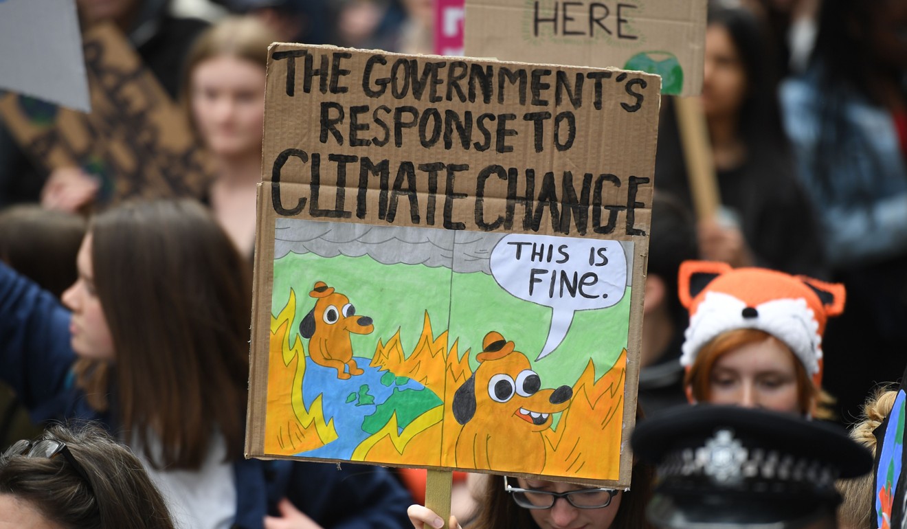 Supporters carry placards as they march during the YouthStrike4Climate demonstration in central London on April 12. Photo: AFP