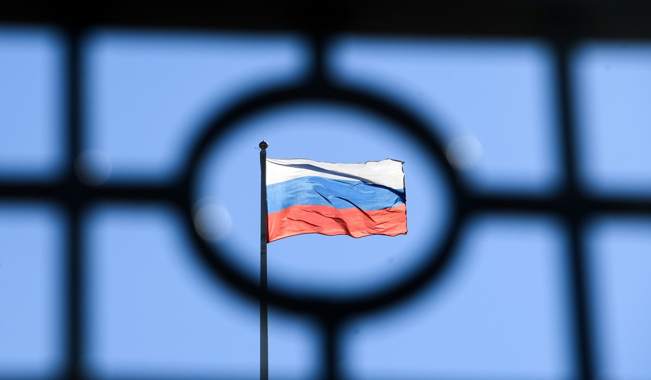 A Russian flag is seen at the top of the Moscow City Court. Photo: AFP