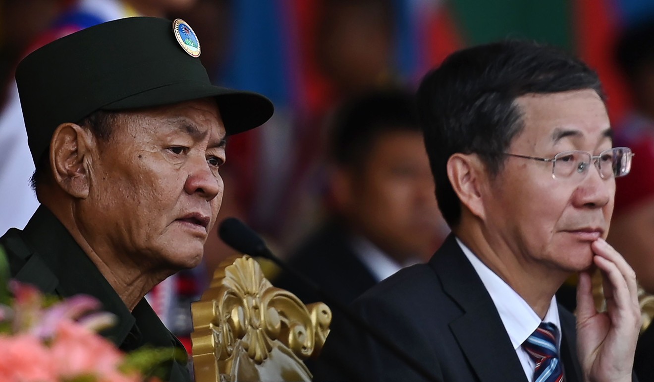 United Wa State Army (UWSA) leader Bao Youxiang (L) and China's Foreign Ministry's special envoy for Asian Affairs Sun Guoxiang watch a military parade, to commemorate 30 years of a ceasefire signed with the Myanmar military in the Wa State. Photo: AFP