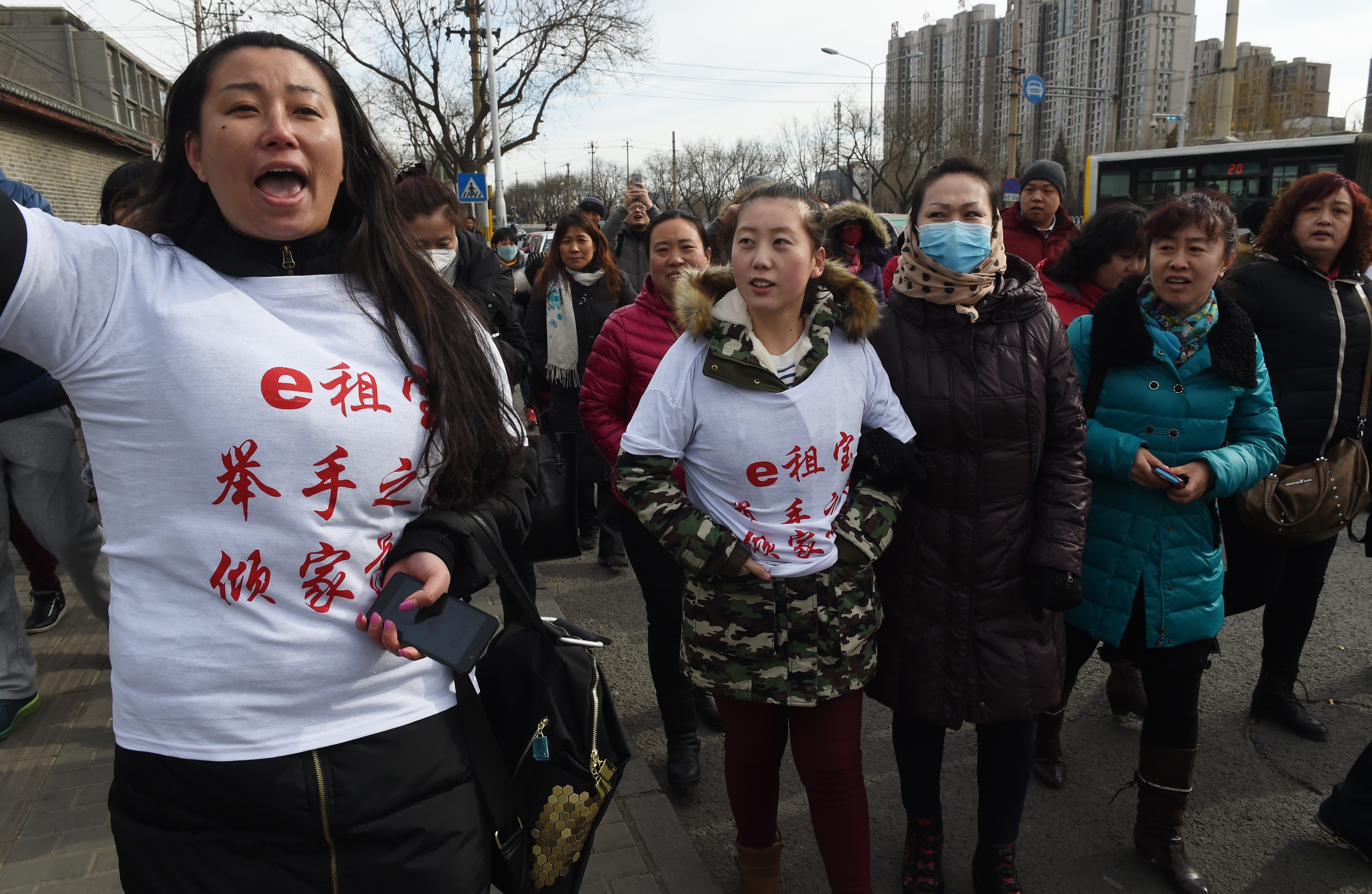This photo taken on February 4, 2016 shows investors in Chinese online peer-to-peer lender Ezubao chanting slogans during a protest in Beijing. The protest came days after China announced that 21 people had been arrested on suspicion of defrauding around 900,000 people of more than 50 billion yuan, after Ezubao turned out to be a giant Ponzi scheme. Photo: Agence France-Presse