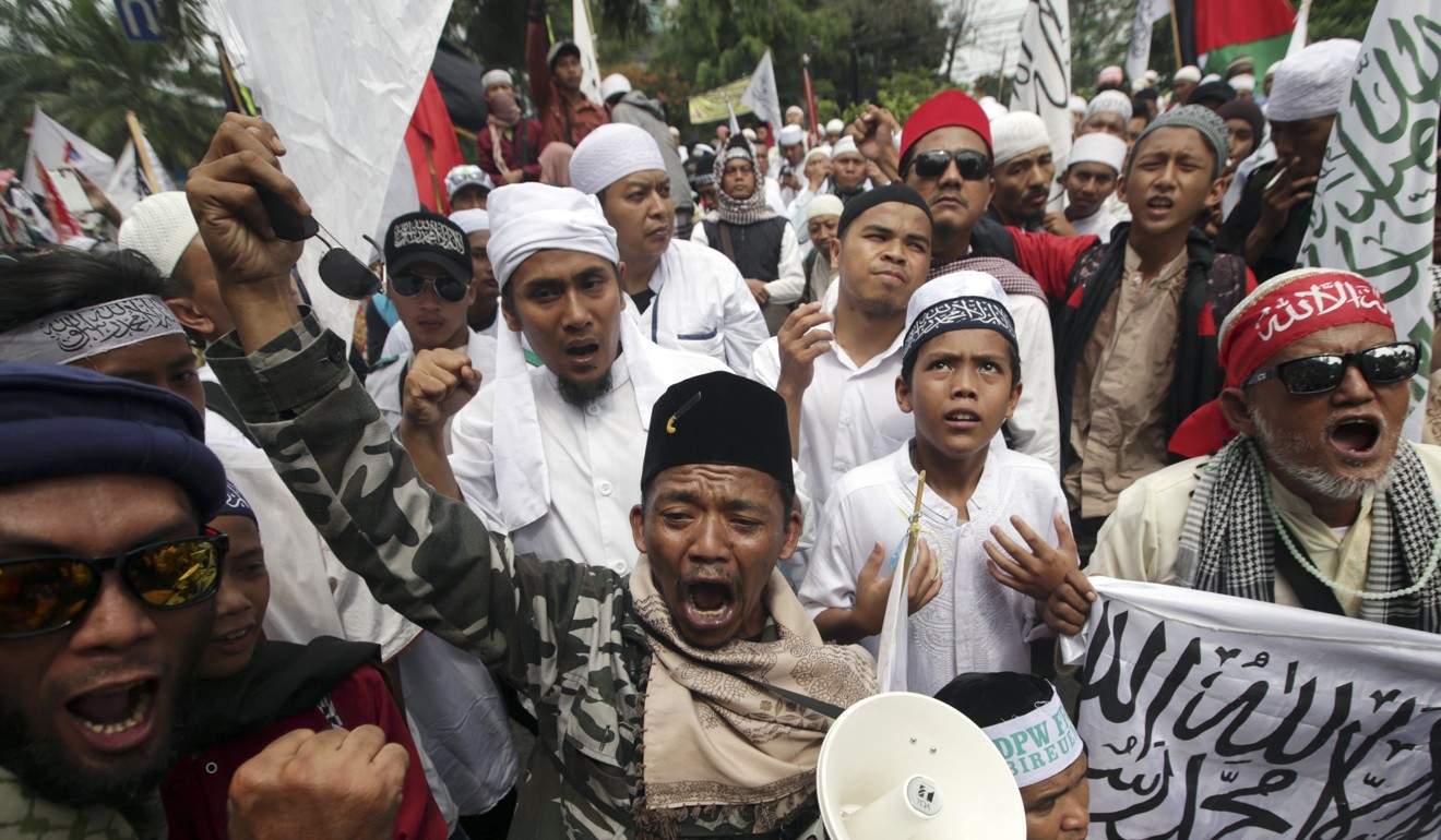 Indonesian Muslims react to Basuki Tjahaja Purnama’s jail sentence. Photo: EPA