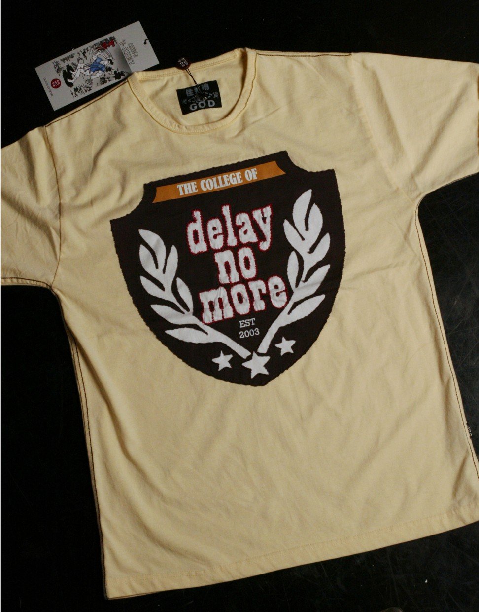 G.O.D. T-shirt displaying the iconic ‘Delay No More’ text. Photo: Edmond So