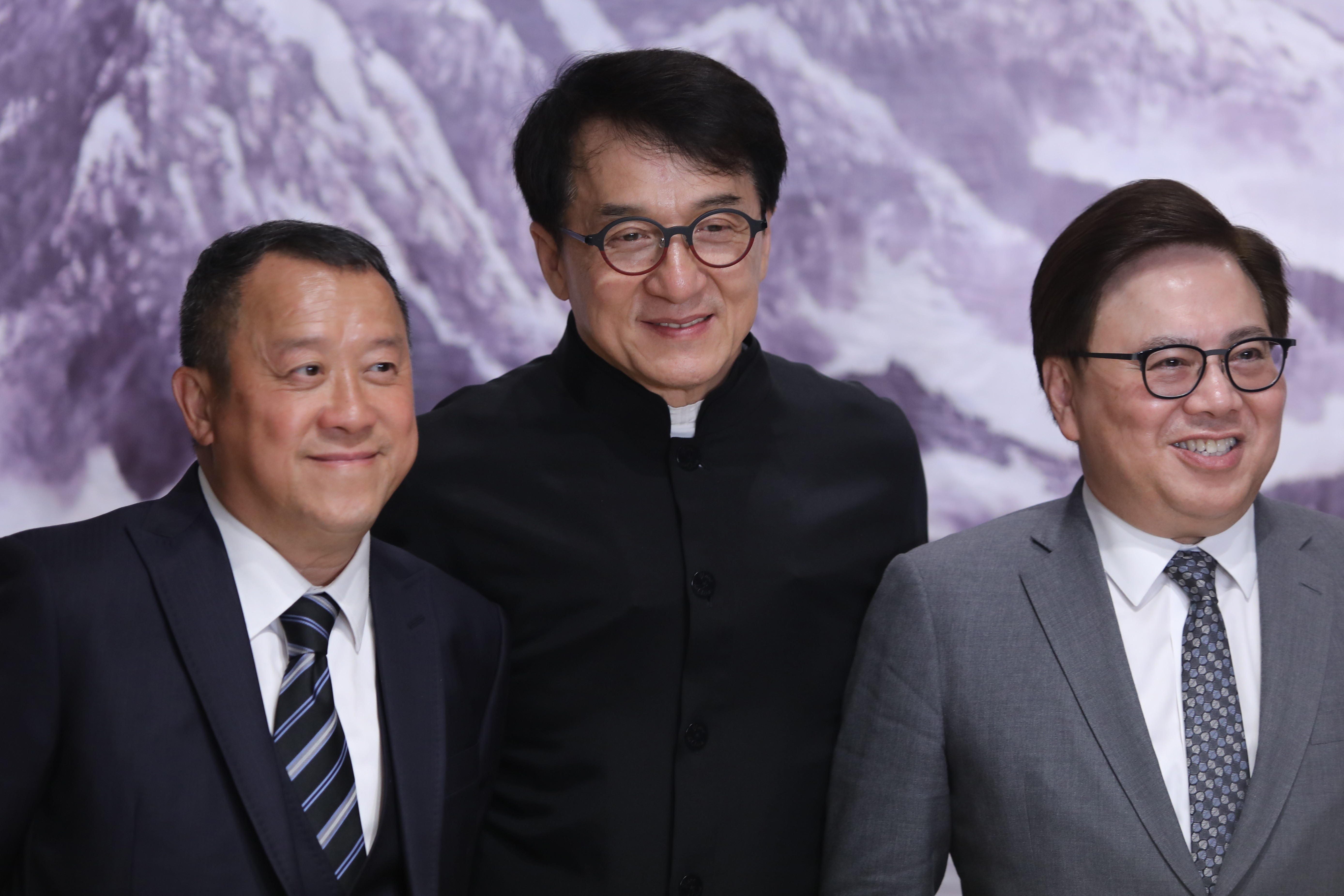 From left, Eric Tsang, Jackie Chan and Wilfred Wong speak to the press in Beijing. Photo: Simon Song