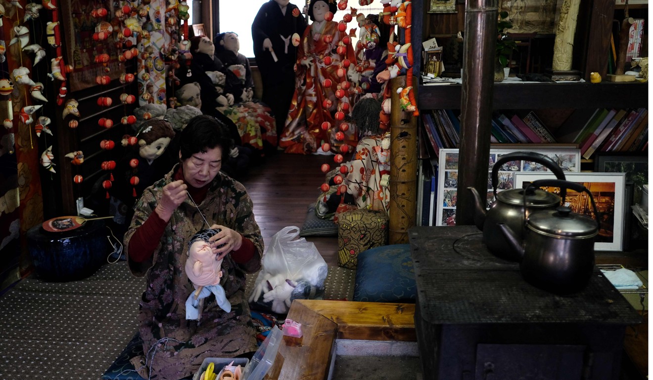 Ayano making the head of a life-size doll at her house. Photo: AFP