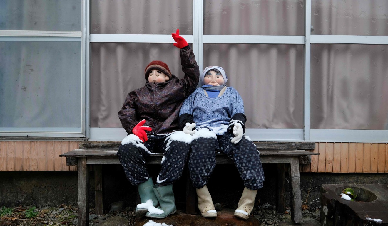 Life-size dolls depicting a farming couple. Photo: AFP