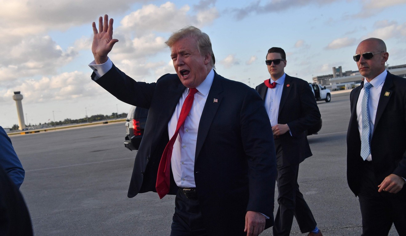 US President Donald Trump waves upon arrival at Palm Beach International airport in Florida on Thursday. Photo: AFP