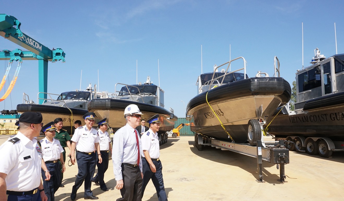 US Ambassador Ted Osius, Centre, walking with Vietnam coastguard members as they inspect patrol boats during a delivery ceremony in Quang Nam in 2017, part of an ongoing move to increase cooperation amid tension in the disputed South China Sea. Photo: US Embassy in Hanoi via AP)