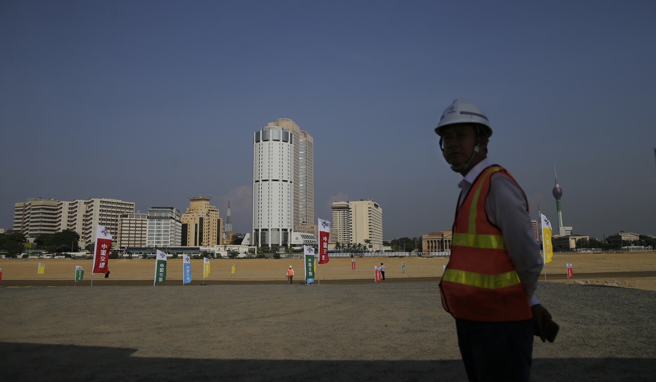 A Chinese construction worker stands on reclaimed land for the Colombo Port City project, initiated as part of China’s Belt and Road Initiative. Photo: AP Photo